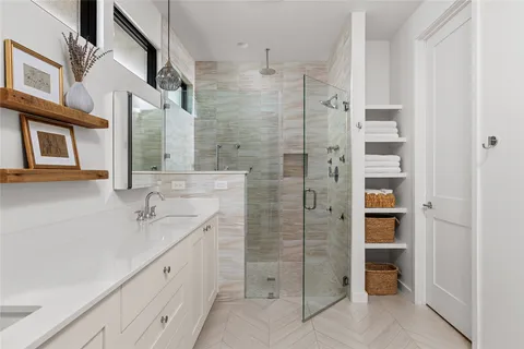 a bathroom with a double vanity sink and a mirror