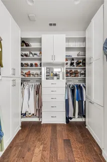 a spacious bathroom with a shower and a double vanity sink a mirror