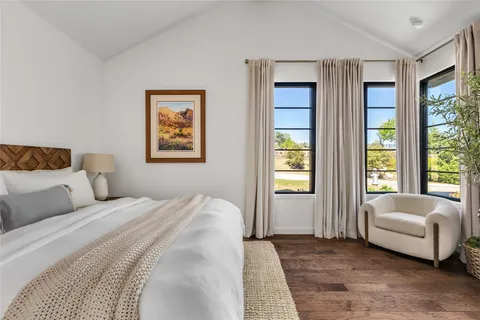 a bedroom with a large bed and a window