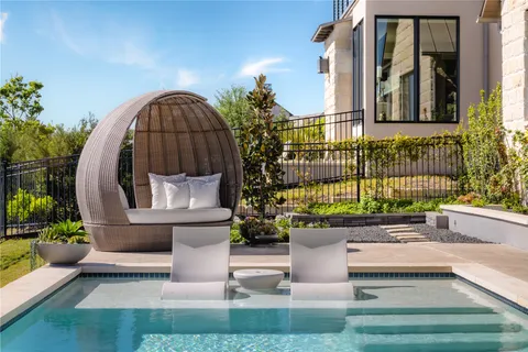 a balcony with chairs and a table