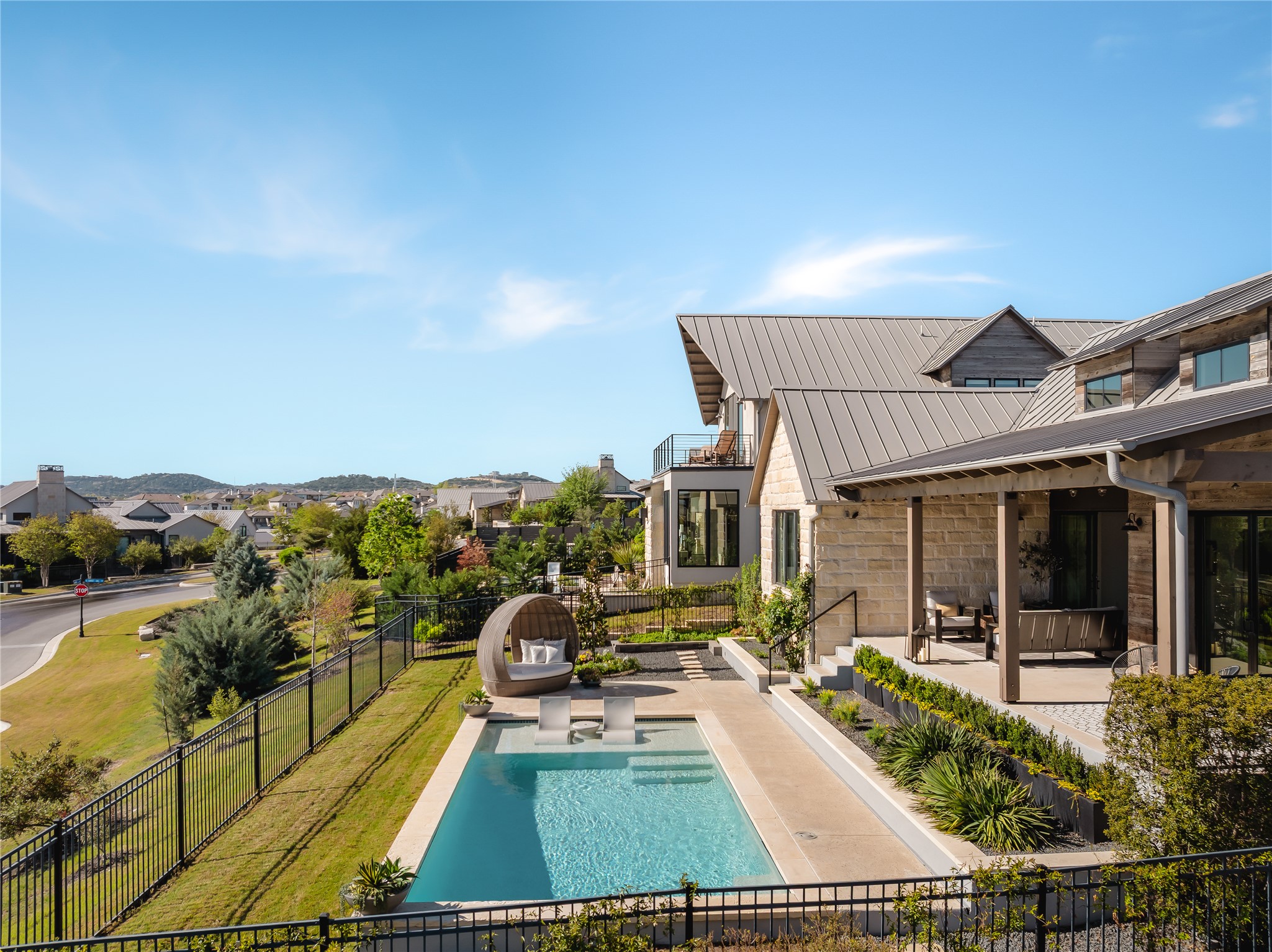 412 Kayak Way Lakeway, TX 78738 - Photo 28 of 32 a view of a patio with couches table and chairs under an umbrella