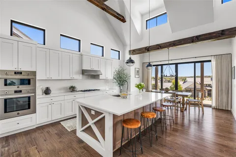 a open kitchen with white cabinets and stainless steel appliances