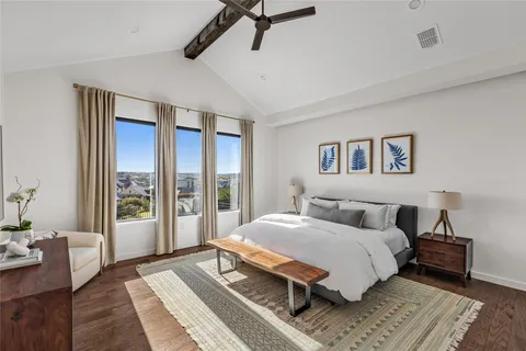 a bedroom with a large bed and a window