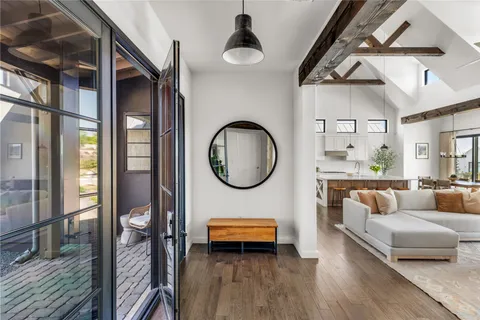 a living room with furniture and a wooden floor