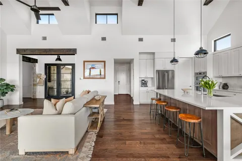 a living room with furniture wooden floor and a table