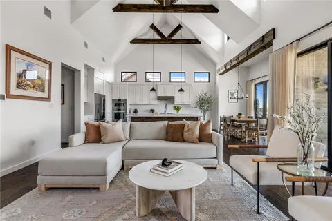 a living room with furniture and a chandelier