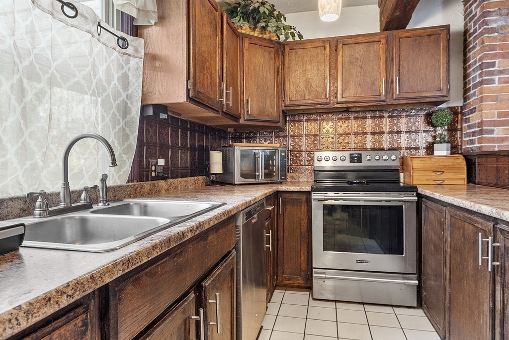 199 High Street Athol, MA 01331 - Photo 11 of 37 a kitchen with granite countertop a sink stove and cabinets