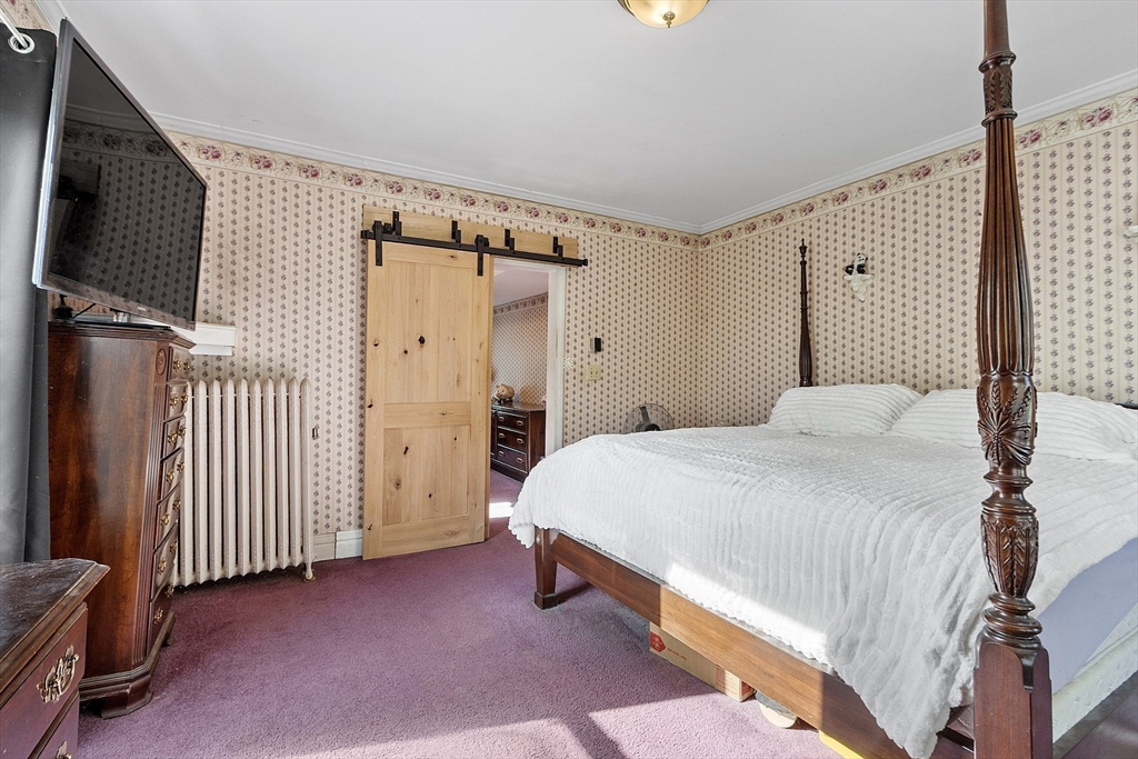 199 High Street Athol, MA 01331 - Photo 22 of 37 a bedroom with a bed and a flat tv screen on wall