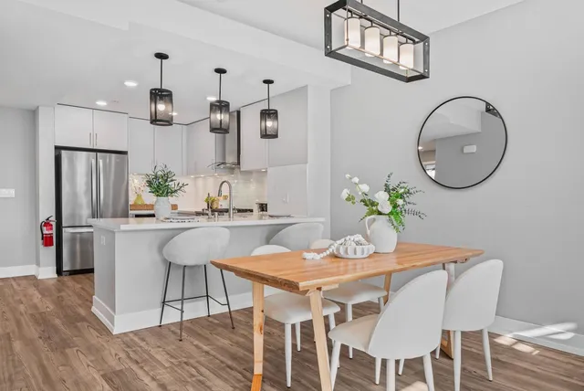a view of a dining room with furniture and wooden floor