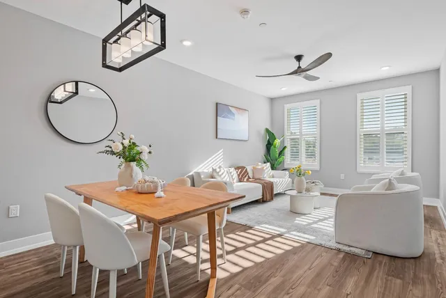 a dining room with furniture a window and wooden floor