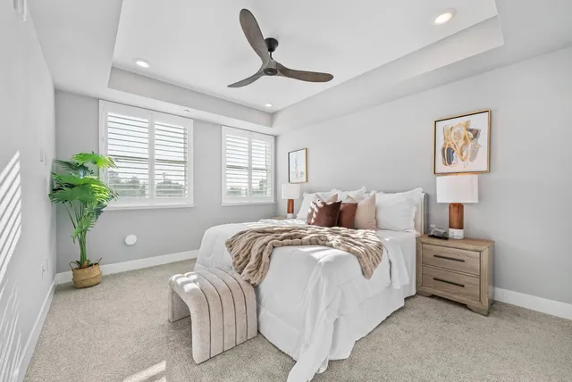 a bed room with bed and a potted plant