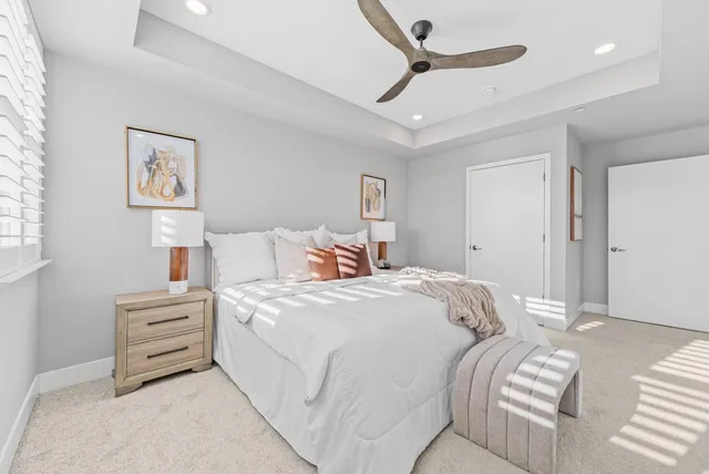 a bedroom with a bed and a ceiling fan