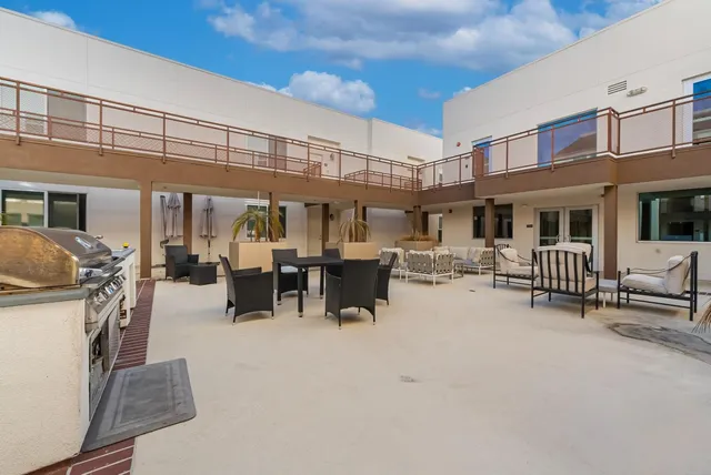 a view of a patio with table and chairs