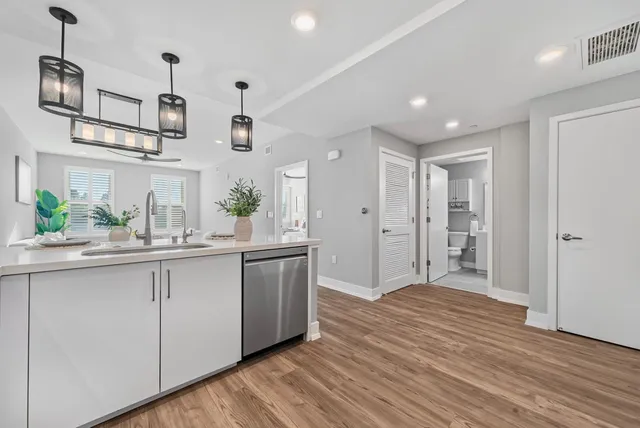 a kitchen with stainless steel appliances granite countertop a refrigerator and a sink