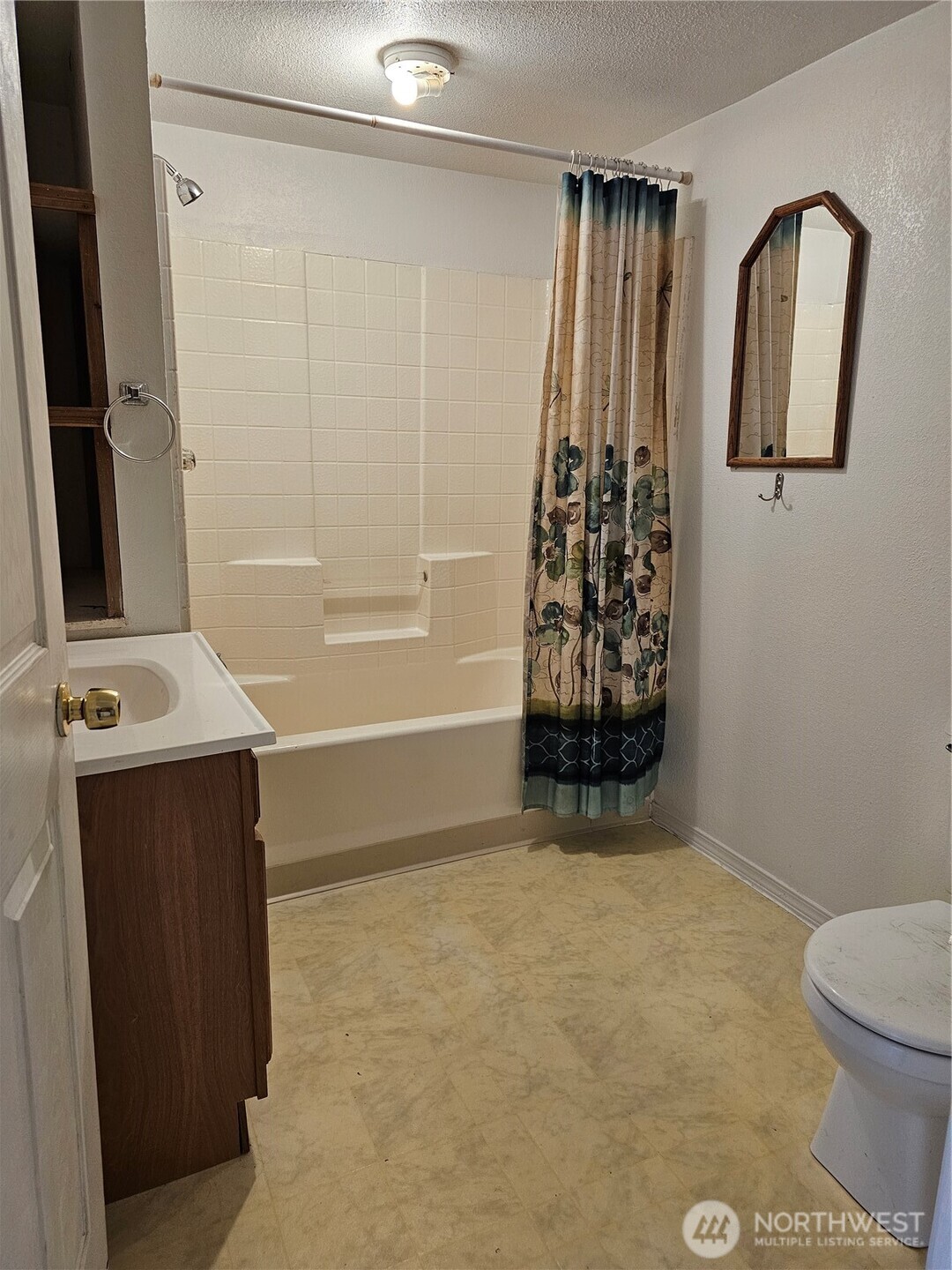 417 Monroe Street Hoquiam, WA 98550 - Photo 13 of 27 a bathroom with a granite countertop sink a toilet and a mirror