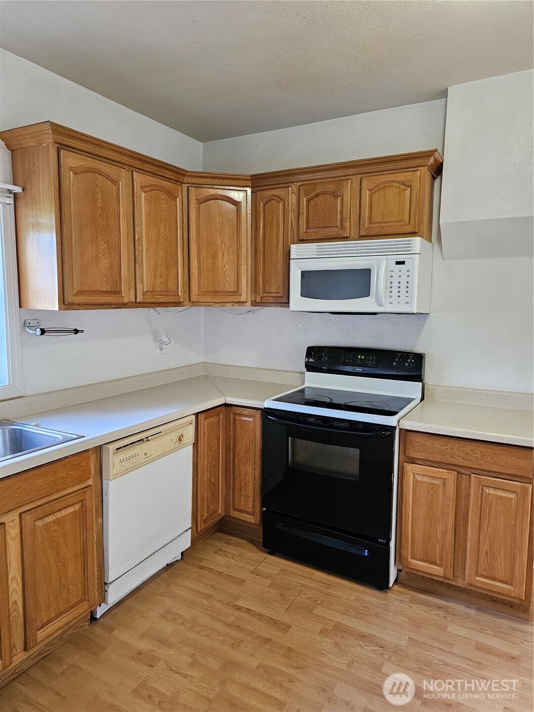417 Monroe Street Hoquiam, WA 98550 - Photo 6 of 27 a kitchen with granite countertop a stove and a sink