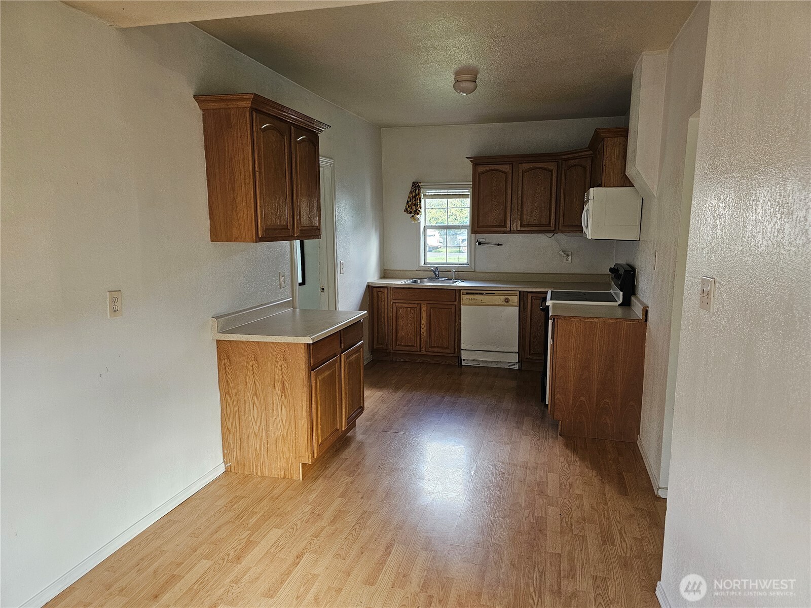 417 Monroe Street Hoquiam, WA 98550 - Photo 8 of 27 a kitchen with stainless steel appliances granite countertop a sink stove and refrigerator