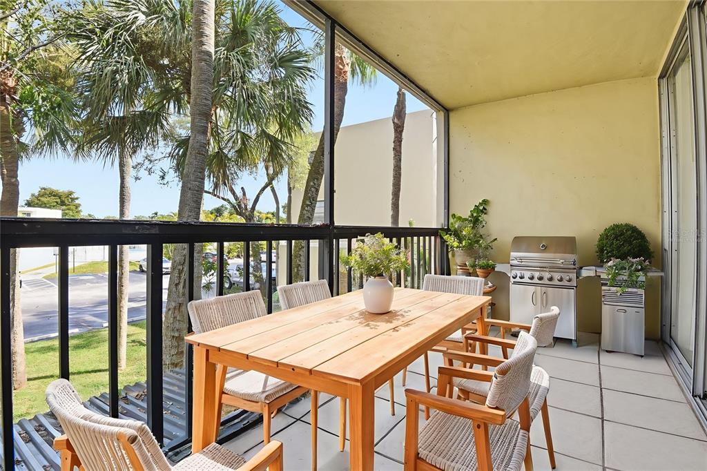 10875 Southwest 112th Avenue, Unit 202 Miami, FL 33176 - Photo 11 of 26 a view of a patio with a table and chairs
