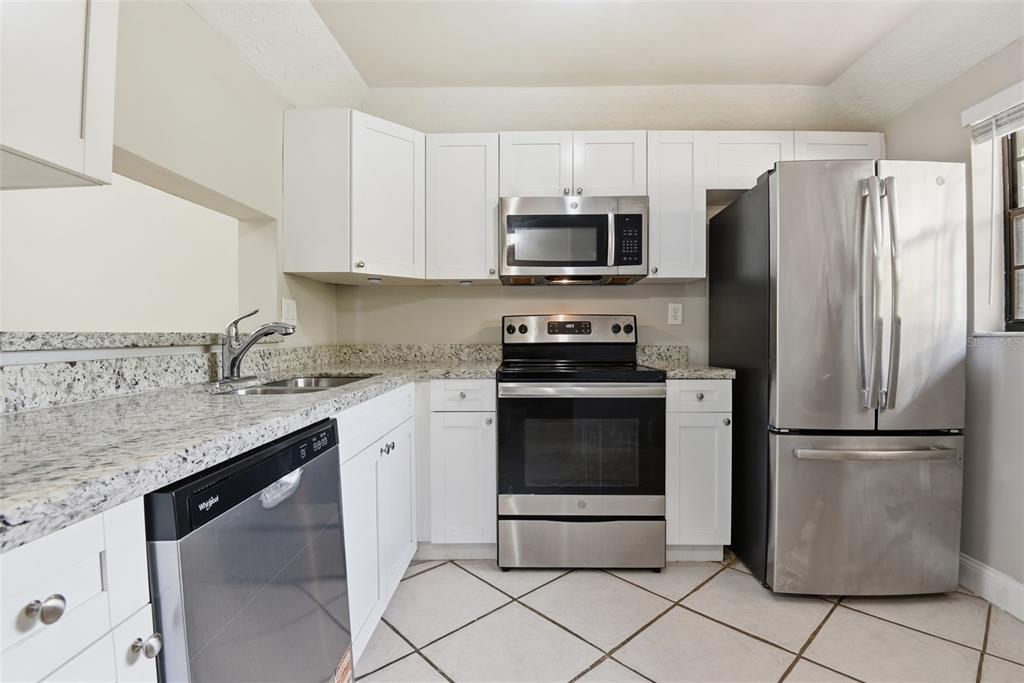 10875 Southwest 112th Avenue, Unit 202 Miami, FL 33176 - Photo 16 of 26 a kitchen with stainless steel appliances granite countertop a refrigerator sink and microwave