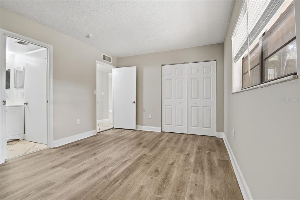 10875 Southwest 112th Avenue, Unit 202 Miami, FL 33176 - Photo 19 of 26 a view of an empty room with wooden floor and a window