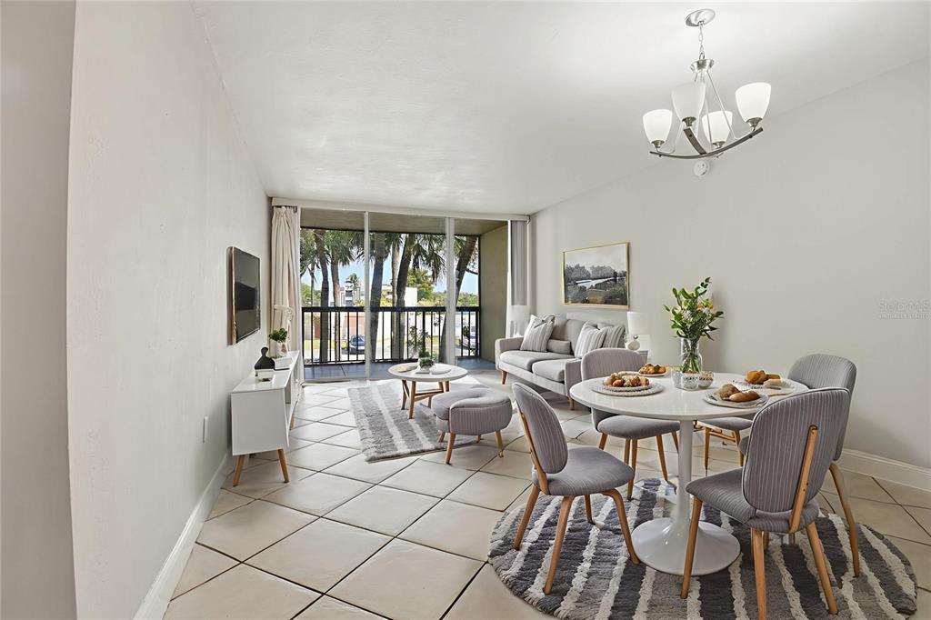 10875 Southwest 112th Avenue, Unit 202 Miami, FL 33176 - Photo 5 of 26 a view of a dining room with furniture wooden floor and chandelier