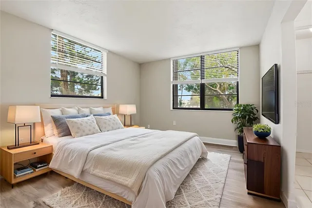 a bedroom with bed and a potted plant