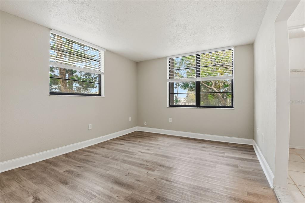 10875 Southwest 112th Avenue, Unit 202 Miami, FL 33176 - Photo 8 of 26 a view of an empty room with wooden floor and a window