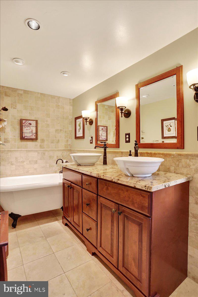 3401 Eisenbrown Road Reading, PA 19605 - Photo 23 of 44 a spacious bathroom with a granite countertop sink and a large mirror