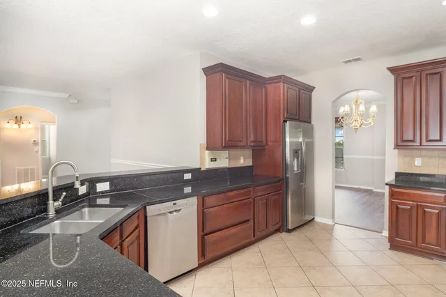 a kitchen with stainless steel appliances granite countertop a sink and cabinets