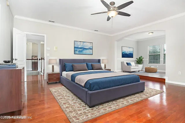 a spacious bedroom with a bed couch and window