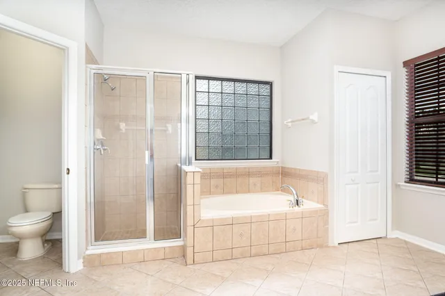 a spacious bathroom with a bathtub and shower