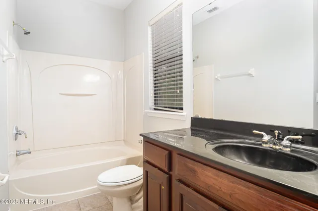 a bathroom with a sink a toilet and tub