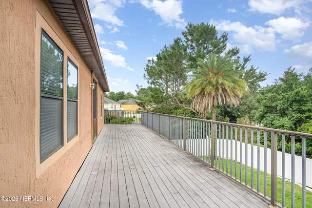a view of balcony with wooden floor and fence
