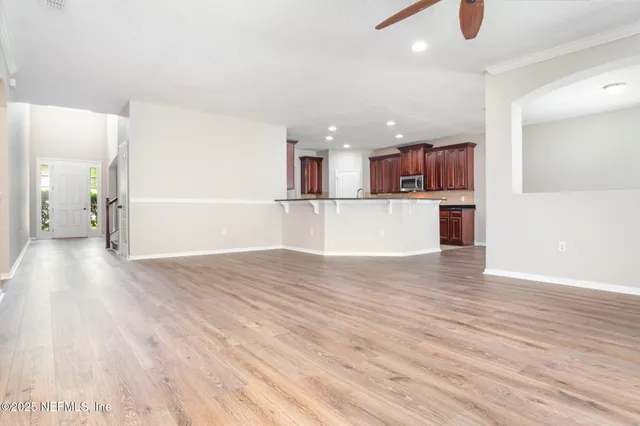 a kitchen with a wooden floor and a window