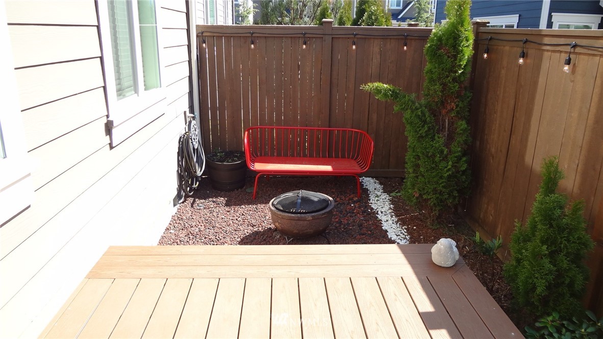 4316 186th Street Southeast Bothell, WA 98012 - Photo 22 of 33 a wooden bench sitting in front of a building