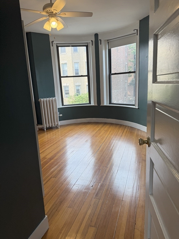 36 Orkney Road, Unit 3 Boston, MA 02135 - Photo 1 of 11 wooden floor in an empty room with a window