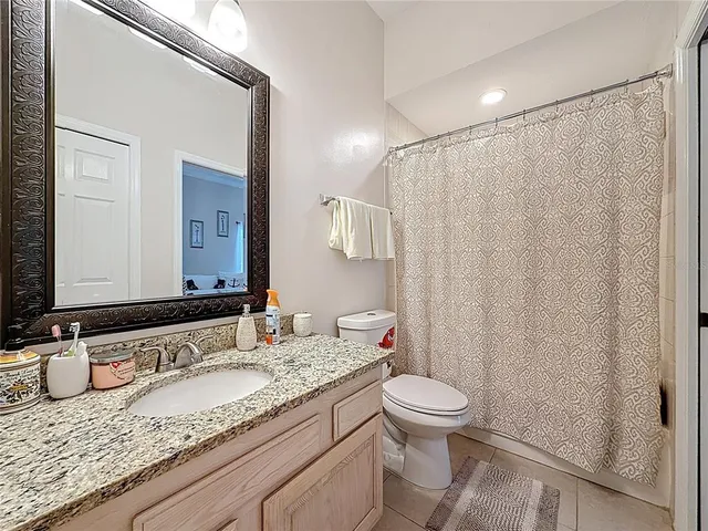 an aerial view of residential house with outdoor space and trees all around
