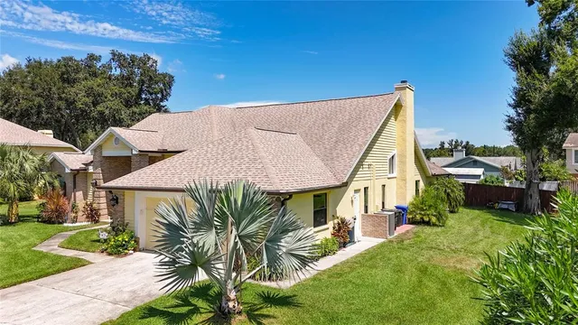a view of a house with a yard and sitting area