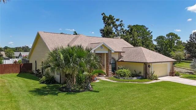 an aerial view of residential houses with outdoor space and trees