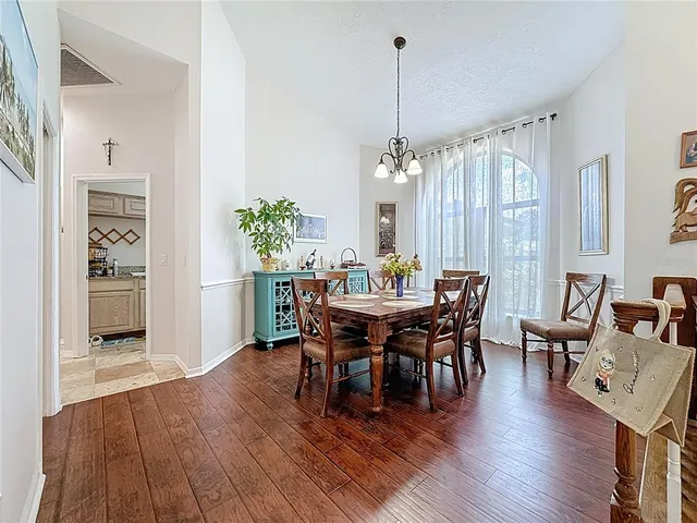 a living room with furniture and a fireplace with wooden floor