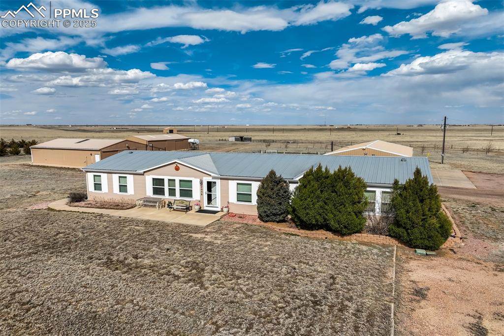 22038 County Road 2 Rush, CO 80833 - Photo 11 of 50 View of front of property with entry steps, a patio area, and metal roof