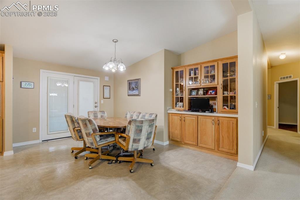 22038 County Road 2 Rush, CO 80833 - Photo 15 of 50 Dining room featuring baseboards, visible vents, and an inviting chandelier