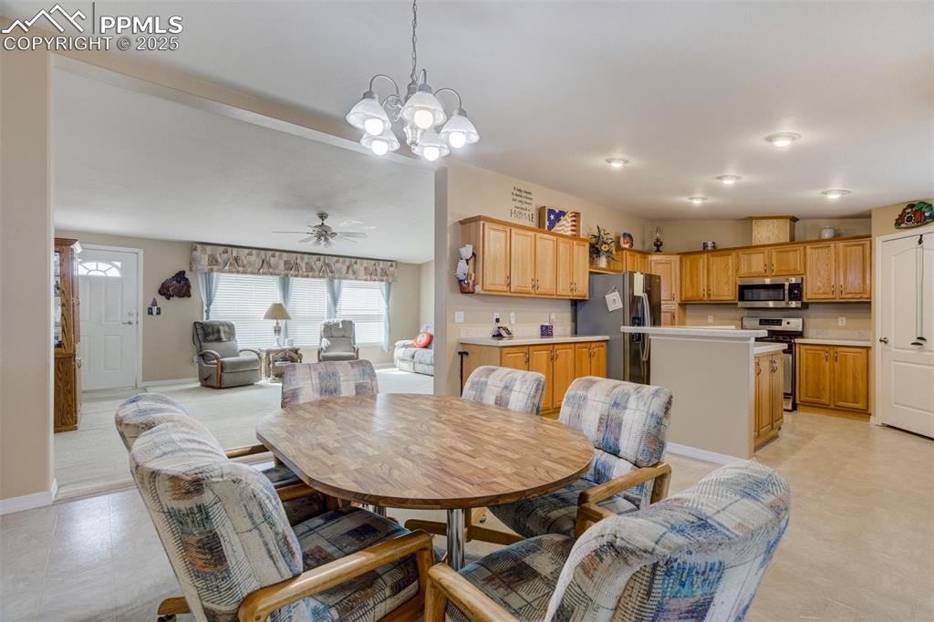 22038 County Road 2 Rush, CO 80833 - Photo 16 of 50 Dining room featuring baseboards, ceiling fan with notable chandelier, and light floors