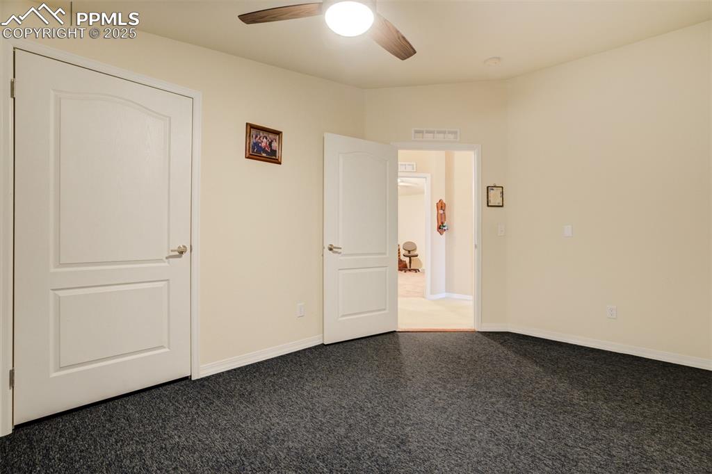 22038 County Road 2 Rush, CO 80833 - Photo 30 of 50 Unfurnished bedroom featuring carpet flooring, baseboards, ceiling fan, and visible vents