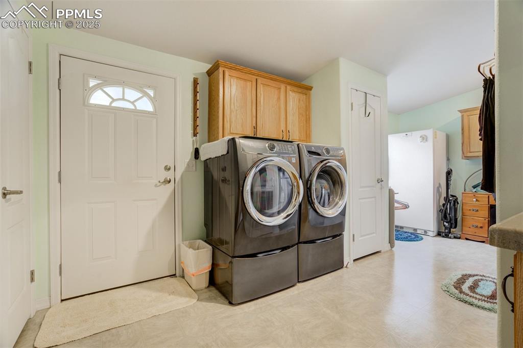 22038 County Road 2 Rush, CO 80833 - Photo 33 of 50 Clothes washing area with cabinet space, washer and clothes dryer, and light floors