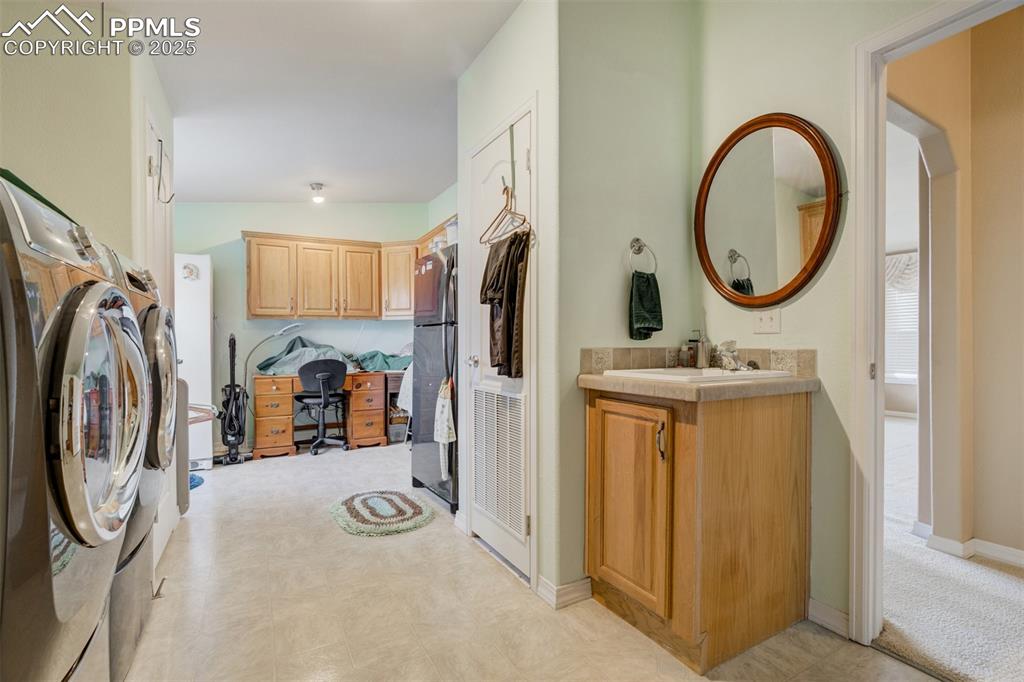 22038 County Road 2 Rush, CO 80833 - Photo 34 of 50 Laundry area with wet bar, washing machine and clothes dryer, laundry area, baseboards, and light colored carpet