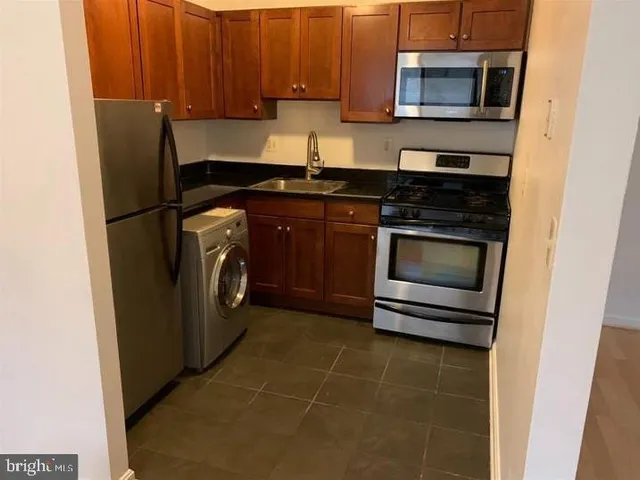 a kitchen with a stove microwave and refrigerator