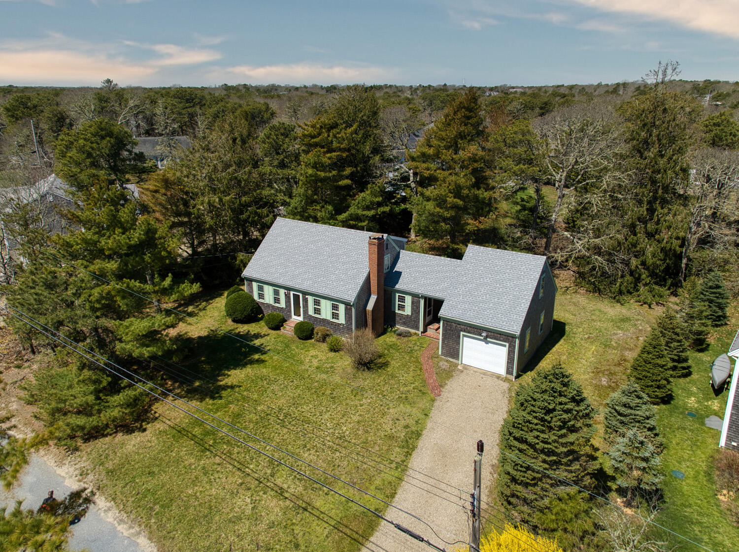 aerial view of a house with a yard and lake view