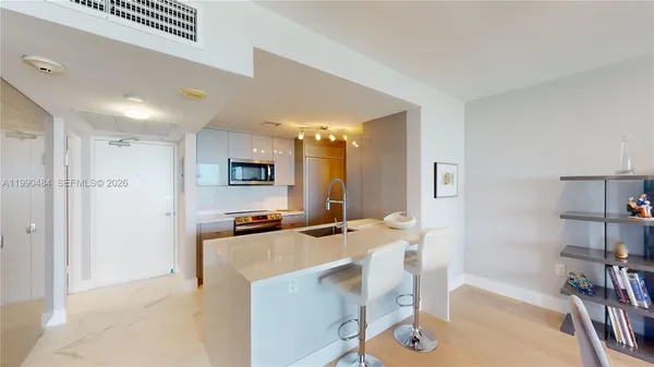 a kitchen that has a microwave a stove and a refrigerator