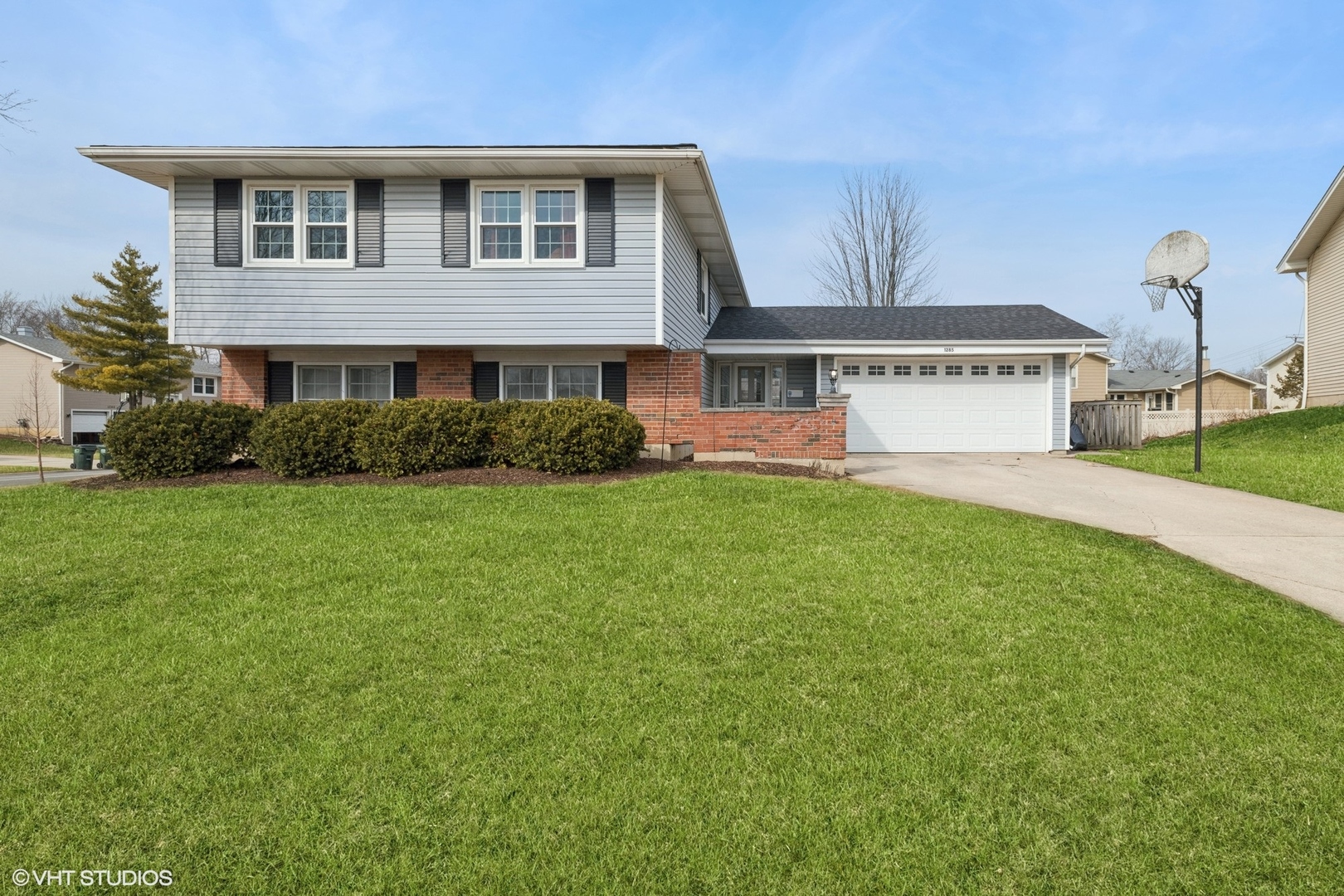 a front view of a house with a yard and garage